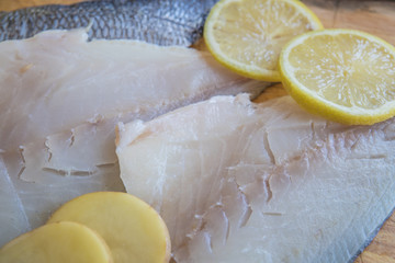 sea bass with potatoes, bakers and lemon