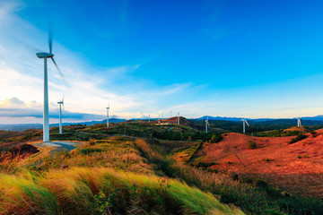 The Pililla Windmills harnessing clean energy during a golden sunset. It is a 54MW wind farm...