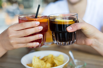 Closeup of friends toasting glasses