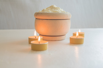 Almond flour with apple candles in wooden bowl