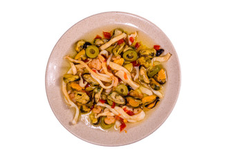 Ceramic plate with the different sea food and olives isolated on white background
