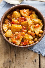 Patatas bravas. Roasted potatoes with chickpeas in tomato sauce. 