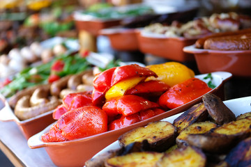 Red and yellow pepper cooked on fire  in street side restaurant. Street food and outdoor cooking concept