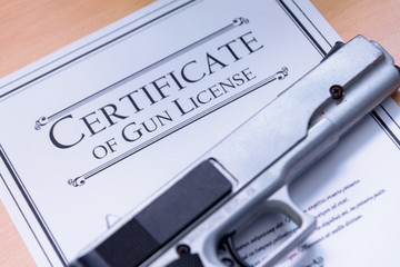 Hangun laying on a Gun / Firearms License Certificate