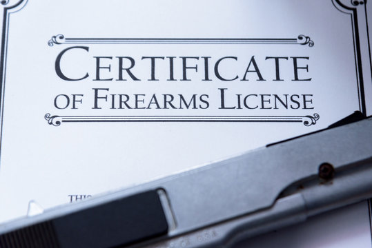 Hangun laying on a Gun / Firearms License Certificate