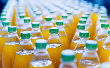 Obraz premium Conveyor with bottles for juice or water. Beverages factory equipments