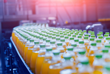 Obraz premium Conveyor with bottles for juice or water. Beverages factory equipments