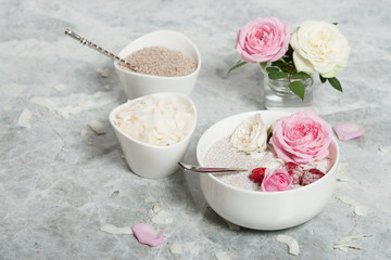 Obraz na płótnie Canvas Chia Seeds Pudding With Coconut. Rose Flowers. Raspberry.