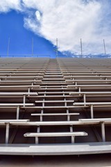 Stadium Bleachers with Blue Sky and Clouds