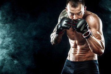 Fototapeta na wymiar Sportsman boxer fighting on black background. Copy Space. Boxing sport concept.