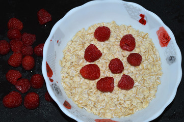 Oatmeal with raspberries in a bowl.