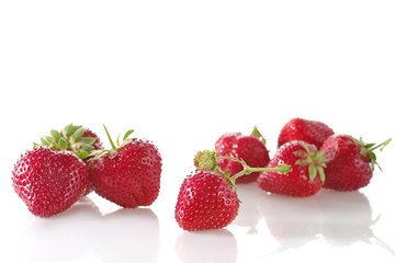 ripe strawberries isolated on white background with a reflection