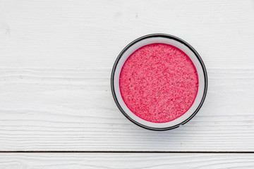 Whipped cranberry semolina porridge vispipuuro from red berries berries on a white old rustic table, Top view, copy space, minimalism