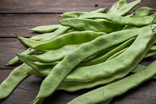 A pile of fresh green beans on table. Green runner beans. Top view