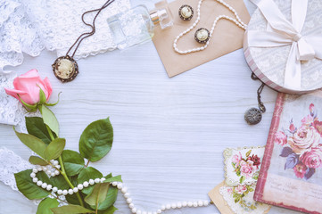 Vintage mockup. Pink rose, lace, pearls, vintage earrings, notebook, old postcards, envelope, pocket watch