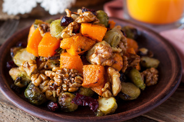 Festive salad with brussels sprout, pumpkin, nuts, cranberries