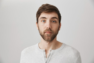 Keep calm and pretend nothing happened. Portrait of calm serious mature male with beard standing...
