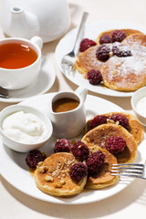 sweet corn pancakes with berries for breakfast, vertical top view