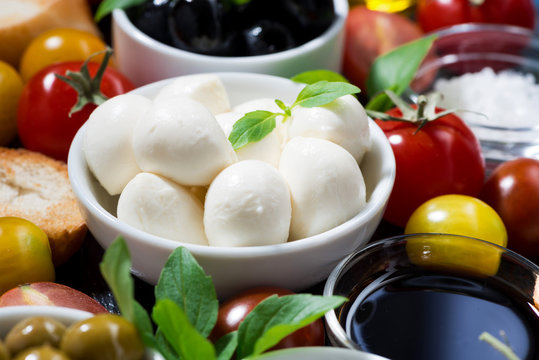 mozzarella, fresh ingredients for the salad and bread, closeup, selective focus