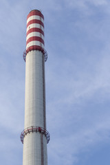Industrial chimney on blue sky background