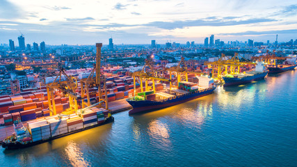 Naklejka premium Container ship in export and import business and logistics. Shipping cargo to harbor by crane. Water transport International. Aerial view and top view.