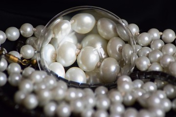 Beautiful jewelry made of pearls under a magnifying glass.