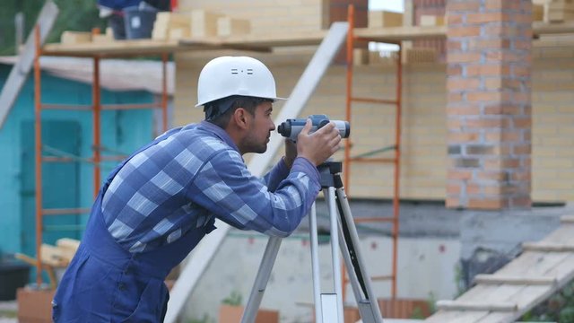 Surveyor performs measuring operations on the level and the theodolite