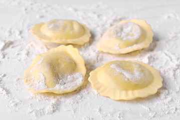 uncooked ravioli on marble