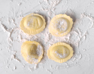 uncooked ravioli on marble