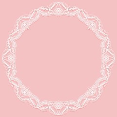 Circular frame with paper lace. Lacy white and pink background.