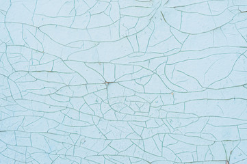 Textured background cracked blue paint on a wooden surface