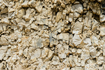 Textured stone background Rubble ballast in natural form in the rock wall