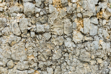 Obraz premium Textured stone background Rubble ballast in natural form in the rock wall
