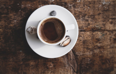 Summer sea vacation concept.  Cup of coffee, sea shells, wooden background
