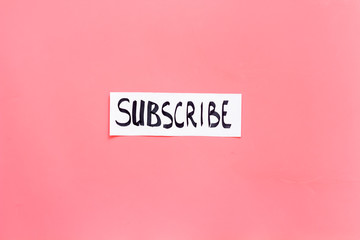 Subscribe template or mockup. Hand lettering subcribe on pink background top view space for text