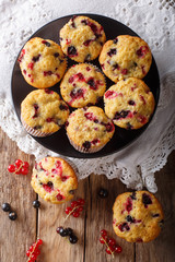 Summer dessert: muffins with a berry mix of currants close-up. Vertical top view from above