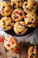 berry muffin with black and red currant close-up. Vertical top view from above