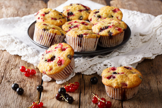 Home-made dessert: muffins with a berry mix of currants close-up on a plate. horizontal