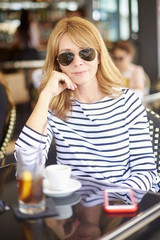 Smiling woman relaxing at coffee shop