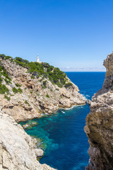 Mallorca, Blue clear sea water in bay between rocks and lighthouse of capdepera