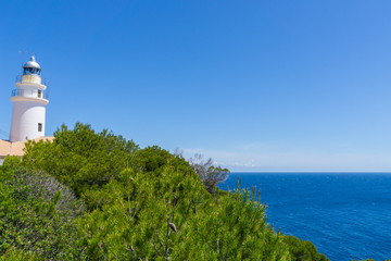 Fototapeta na wymiar Mallorca, Ancient lighthouse of capdepera behind green plants