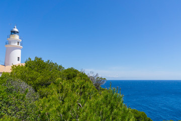 Mallorca, Ancient lighthouse of capdepera behind green plants
