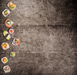 Traditional japanese sushi pieces on rustic concrete background.