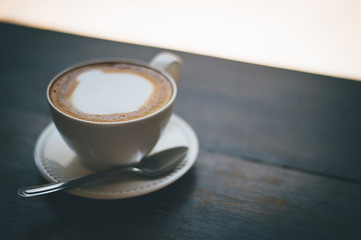 A cup of coffee and coffee beans on the table of coffee lovers coffee.