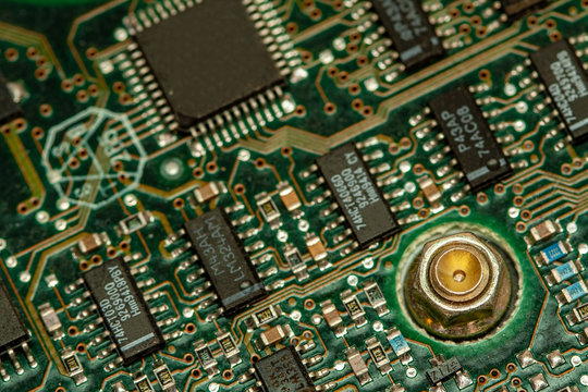 Close up view of the circuit board on the back of a pc hard drive.