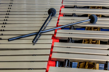 Sticks laying on top of a vibraphone musical instrument
