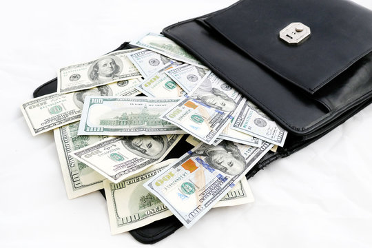 black money bag full of dollars in mouth open,


