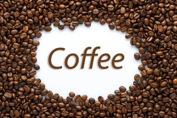 Roasted coffee beans on white background with space for text. top view