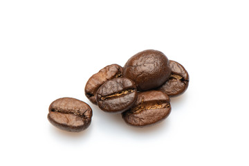 Few roasted coffee seeds isolated on white background