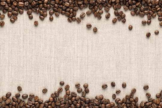 Roasted coofee seeds on canvas background. top view with space for text